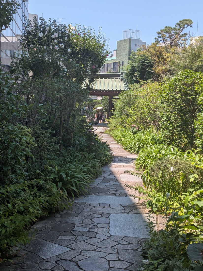 A quiet stone lane leading to a temple gate